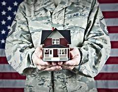 Army person holding a toy house
