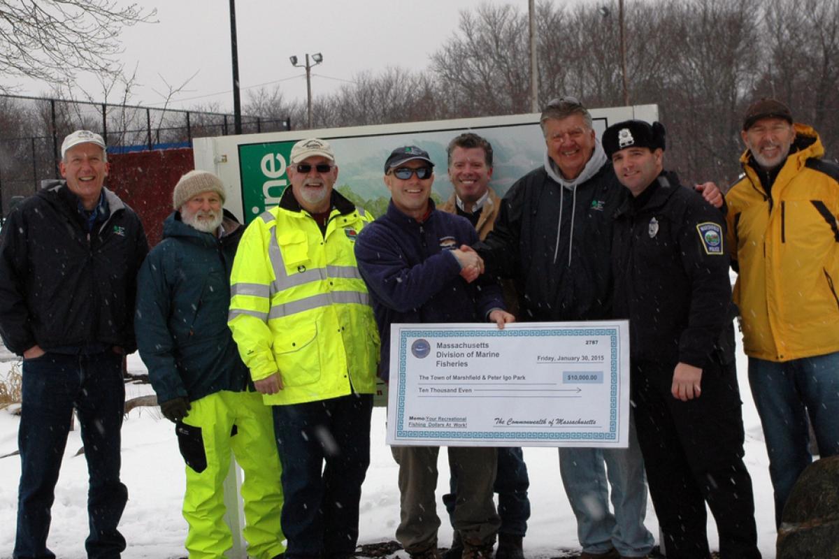DPW Superintendent Tom Reynolds (third from left) and community supporters accept grant funding for Peter Igo Park.